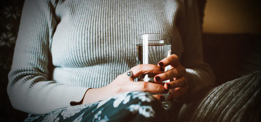 women holding a drinking glass