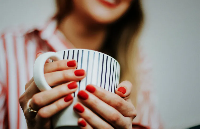 holding hot beverage